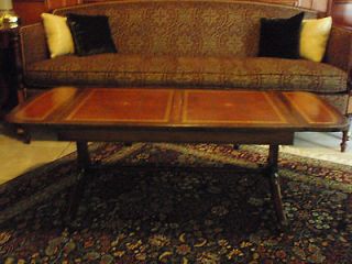   Antique English leather top drop leaf coffee table with casters