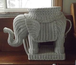 This is a vintage wicker elephant. A foot stool or plant stand.