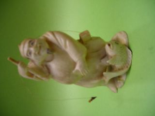 Antique faux ivory happy fishing man figurine with catch of the day 