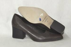 This pair of Marc Alpert dress heels has a brown leather upper. It 