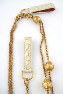You are bidding on a DESIGNER Gold Tone Rhinestone Ball Belt Necklace 