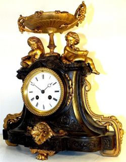   Antique mantel clock two tone gilt figural Cherub chiming mantle clock