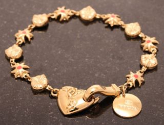  bracelet is presented in gold tone with coral color accents brand
