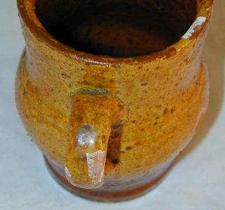  redware creamer with a yellow slip accent to the top the creamer