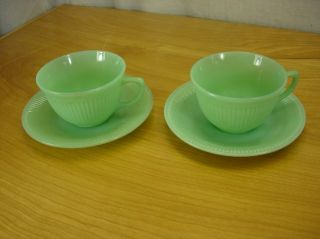  of fire king cups and saucers they are marked oven fire king glass on