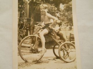 Oldtime Photograph of A Boy on A Giant Sized Tricycle