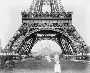 1889 photo Base of Eiffel Tower, with statues in foreground and